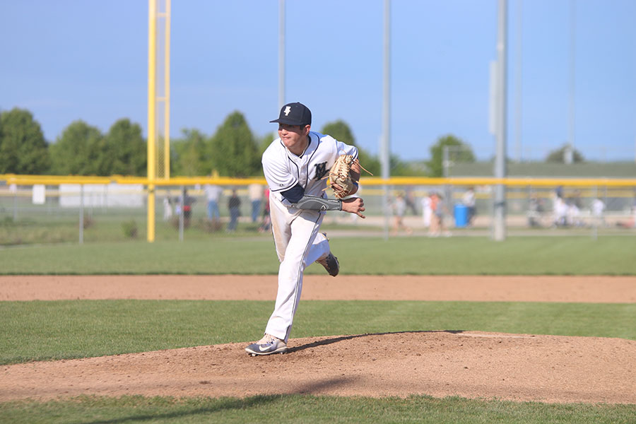 After pitching the ball senior Jack Blancarte watches the ball hit the catchers glove.