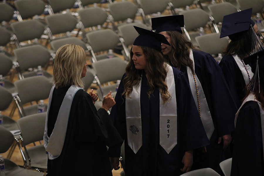 Senior Paige Habiger and associate principal Marilyn Chrisler talk at graduation.