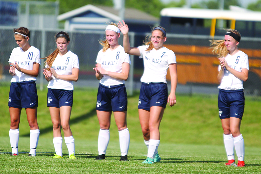 On Tuesday, May 16, the girls soccer team defeats Leavenworth 9-1. Junior Madison Irish steps forward to greet the fans at the home game while team introductions proceed.