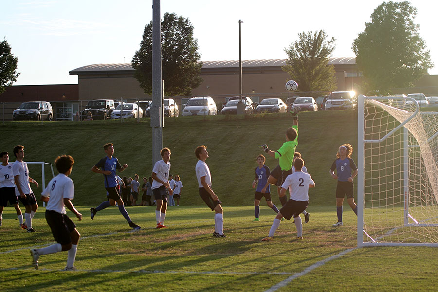 After a corner kick, junior Aiden Veal jumps to try and save a goal.