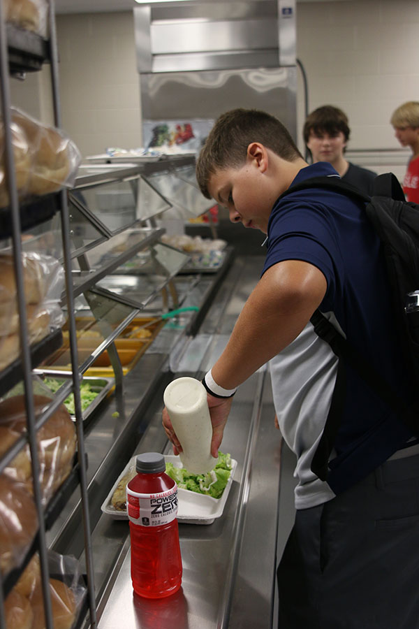 A freshman goes through the lunch line for the first time.