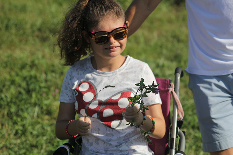 Junior Corinne Brown collects a flower from the pumpkin patch.