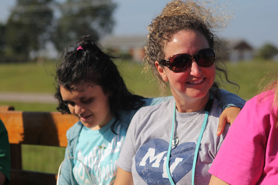 Senior Stef Mayorga enjoys the tractor ride with her teacher.