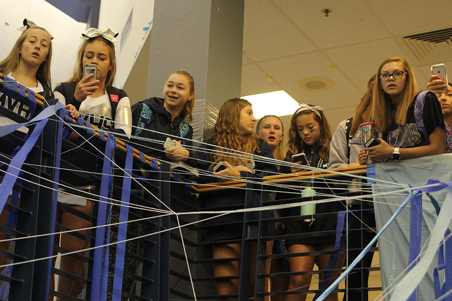 A group of underclassmen watch the Blue Bomb off the balcony of the second floor.