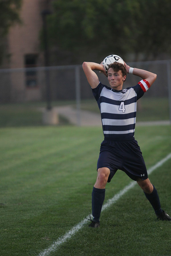 Senior Kyle Franklin throws the ball back into the game after BVW kicks it out during their game on Thursday, Sept. 21.