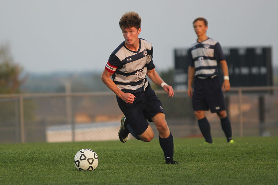 Junior Brock Denney dribbles with the ball.