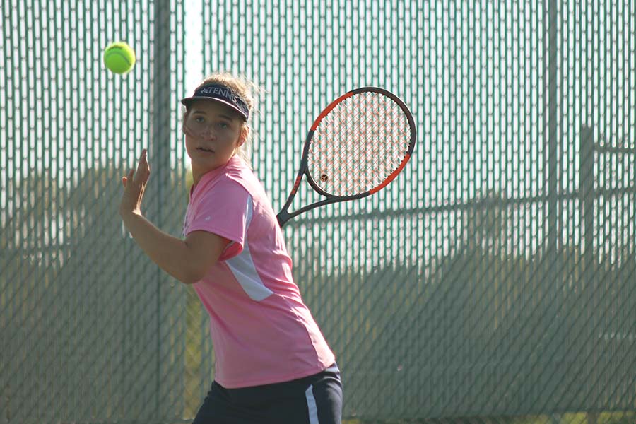 Following the ball with her eyes, senior Tori Wesp prepares to swing her racket on Tuesday, Sept. 19.