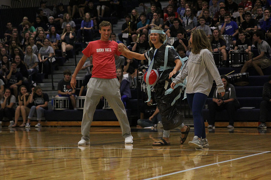 As a part of the class game, juniors Jake Ashford, Haley Puccio and Lilli Milberger laugh as they present their trash bag fashion. 