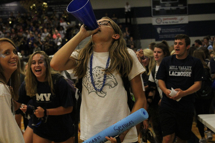 Senior Erin Olson chants Hey Hey Whaddya Say through her megaphone. 