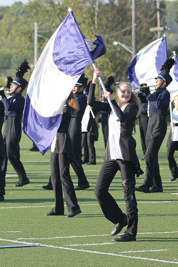 Junior Ally Appl waves her flag during the band competition at Bonner Springs.