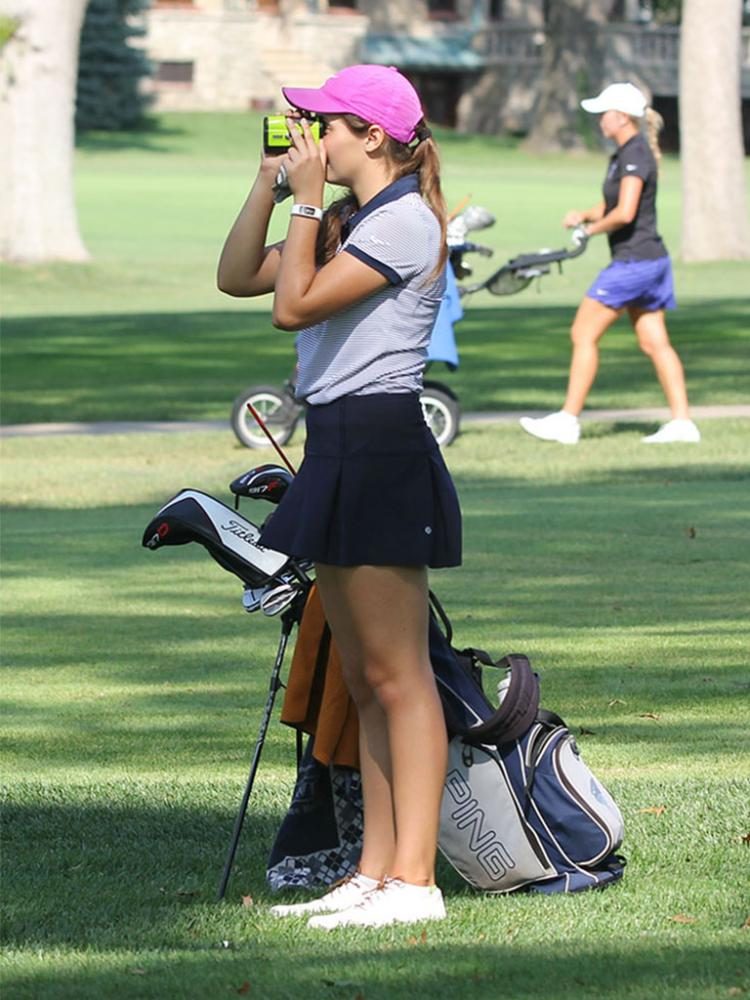 Junior Sarah Lawson uses her range finder to determine the distance to the hole.