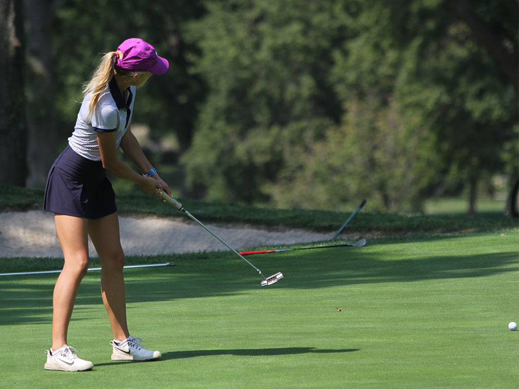 Senior Bella Hadden putts the ball.