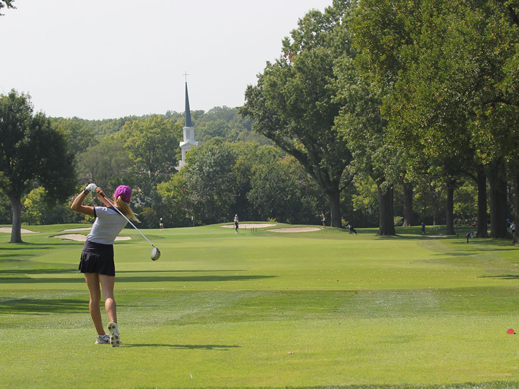 Senior Bella Hadden swings her club to drive the ball.