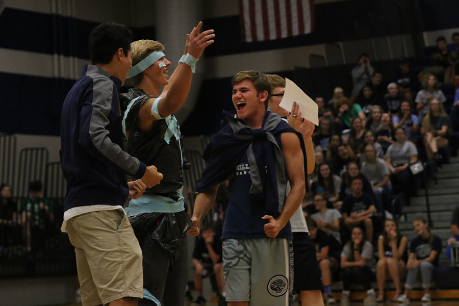 Cheering after winning the class game of a trash bag fashion show, seniors Drake Brizendine, Kyle Hirner and Conner Ward  celebrate on Friday, Sept. 9.