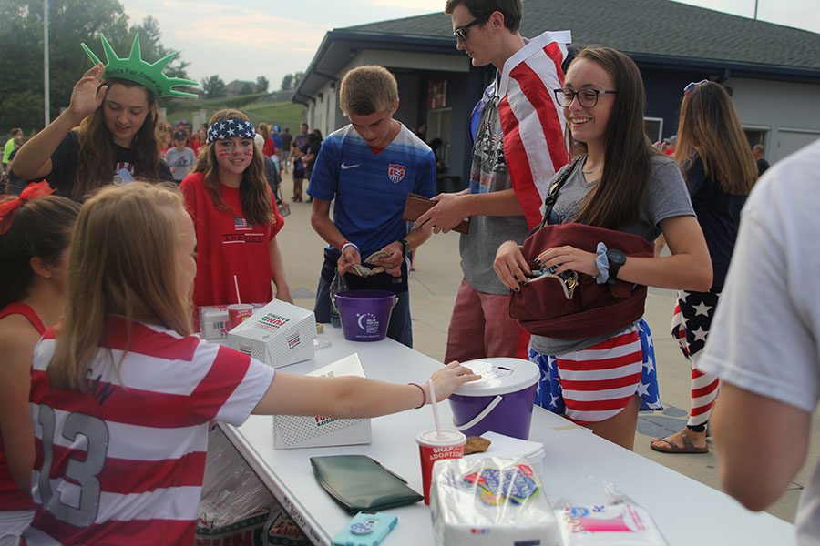 Junior Delaney Kemp waits for her change after donating to Relay For Life at the football scrimmage on Friday, Aug, 25.