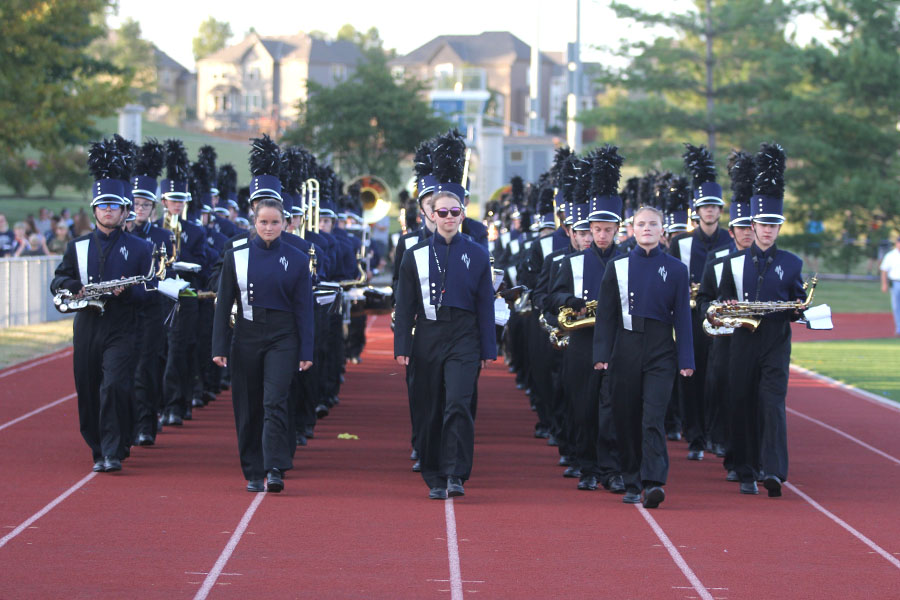 Before the homecoming football game on Friday, Sept. 8, the drum majors lead the band to the bleachers.