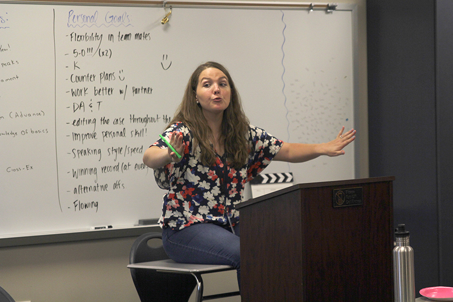 Sitting in front of the class, debate coach Ann Goodson instructs her students during debate camp on Monday, July 24.