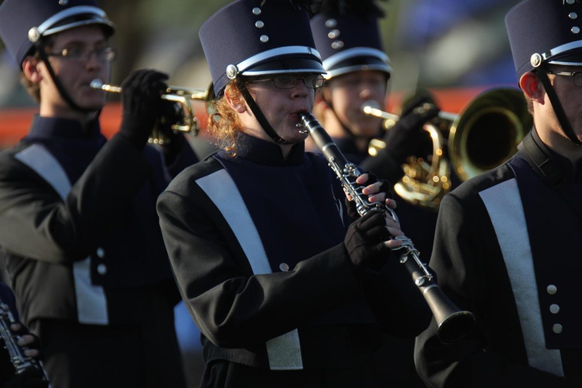 Warming up before the performance, sophomore Griffin Schenk plays his clarinet. 