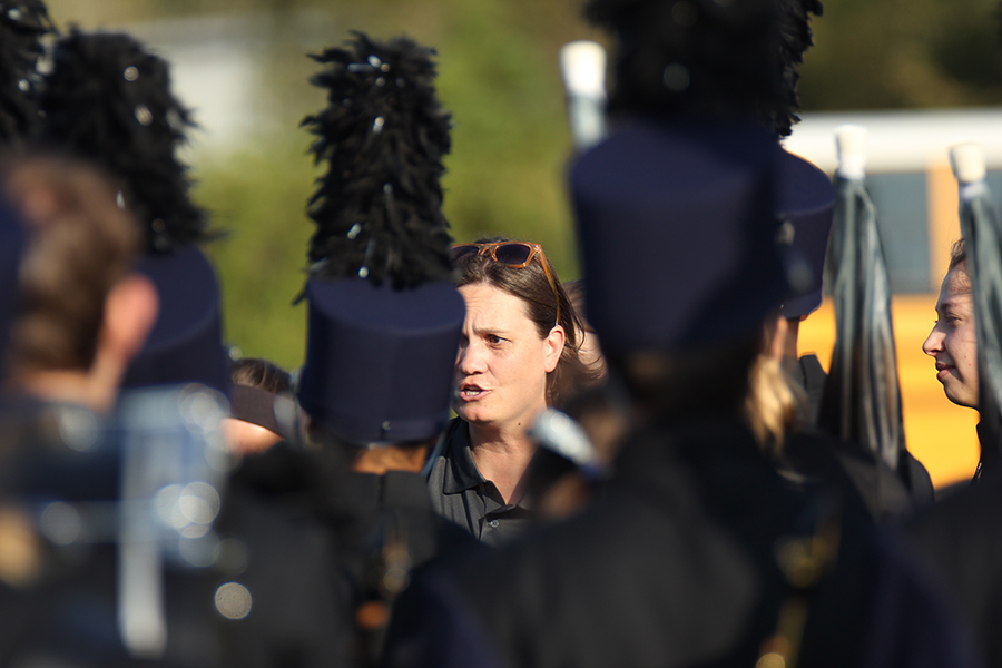 Giving the band last minute advice, band teacher Ms. Steiner leads the group in a huddle to give last minute advice.
