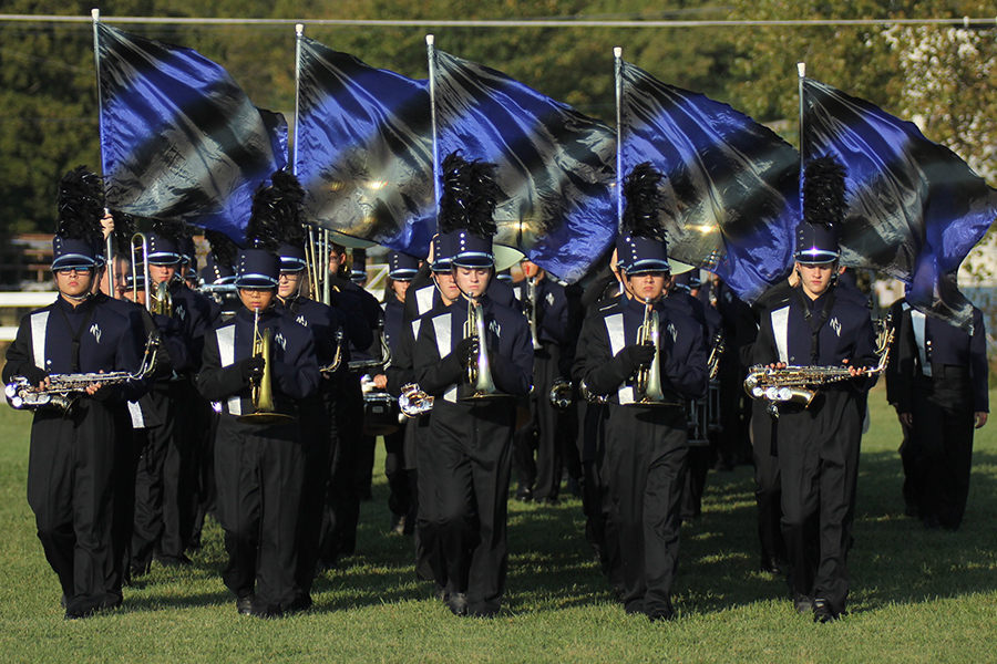 Walking from the practice field to the stadium, the marching band participates in the first band competition of the year at the Bonner Springs Marching Festival on Thursday, Sept. 21.