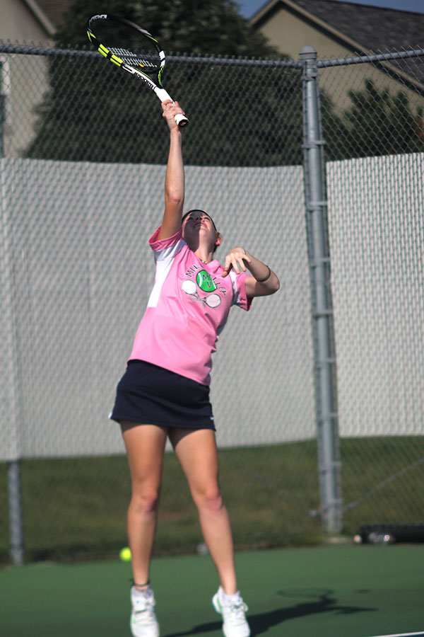 Junior Josie Carey reaches up high to get the ball.