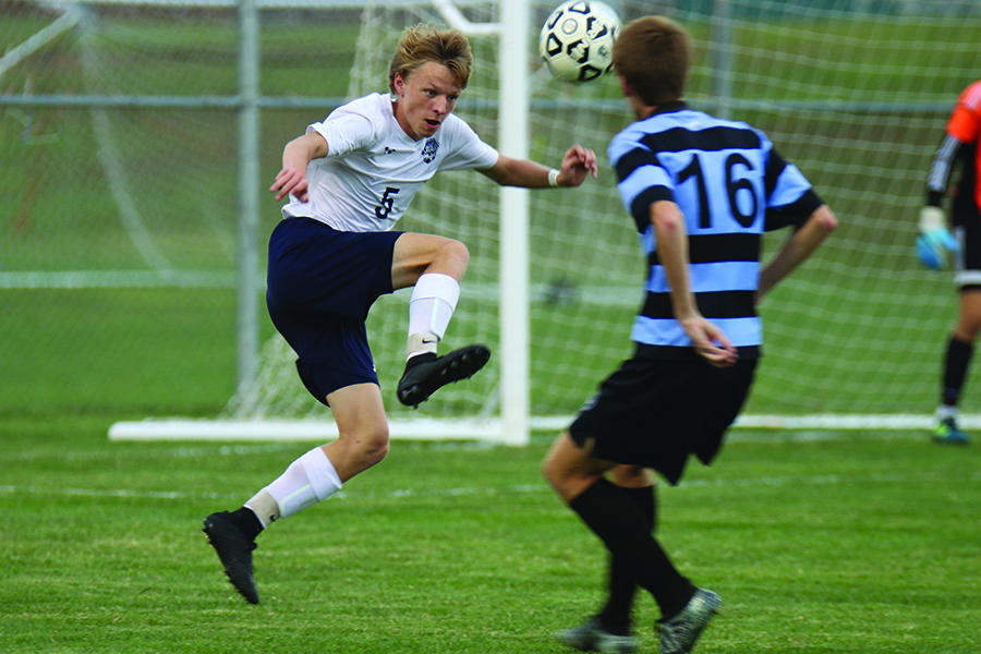 Jumping in the air, sophomore Ian Carroll prepares to receive a pass from a teammate.