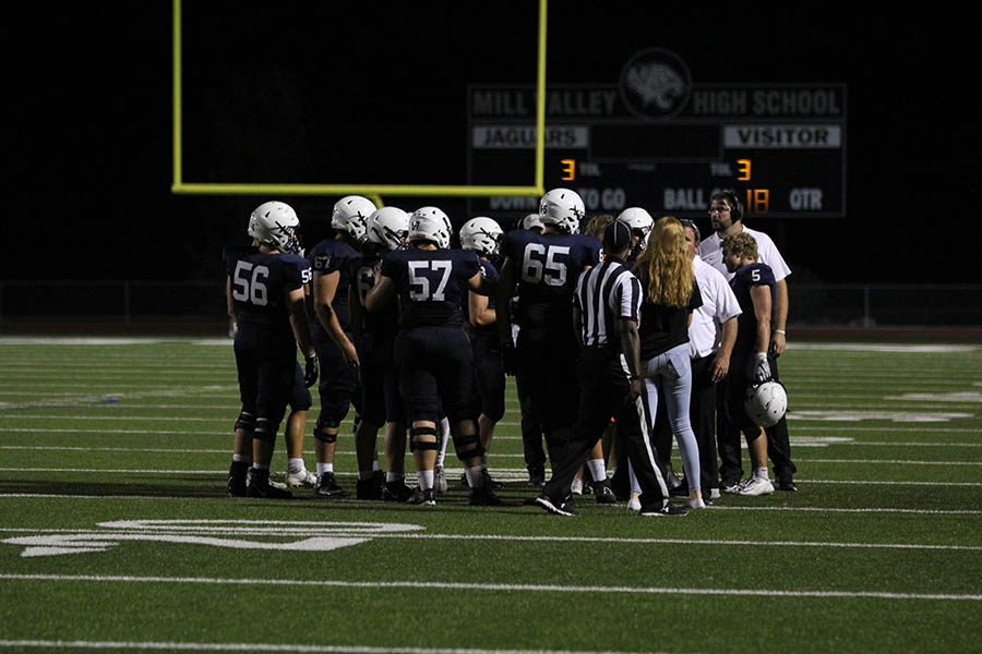 Before going on the field, the offensive players huddle together.