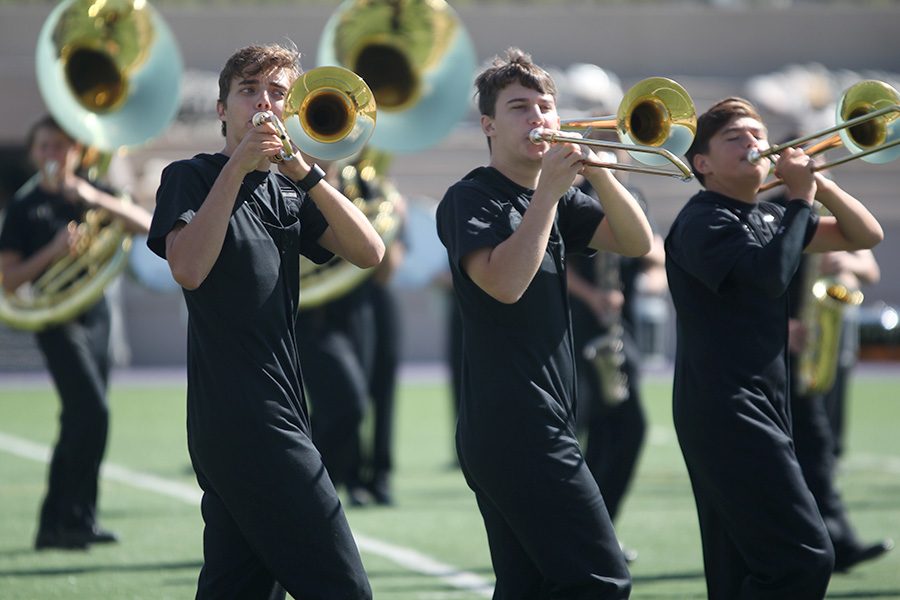 Performing for Kansas State band members, juniors Joe McClain, Johannes Seberger and Ben Stove play their trombones at the clinic. The Marching Jaguars competed at the Central State Marching Festival on Saturday, Oct. 7, earning a superior one rating.