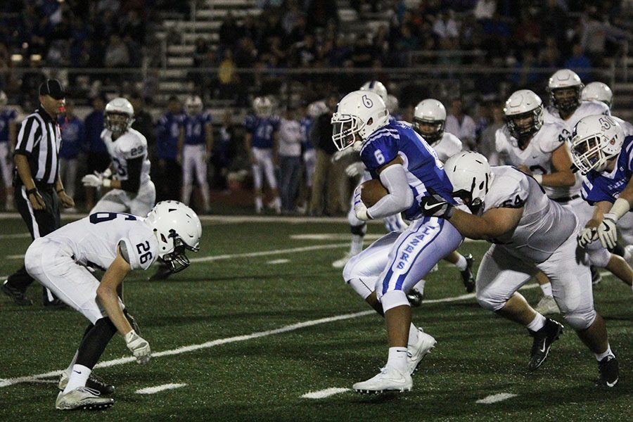 Junior Nick Davie prepares to assist sophomore Justin Sanders tackle a Trailblazer.