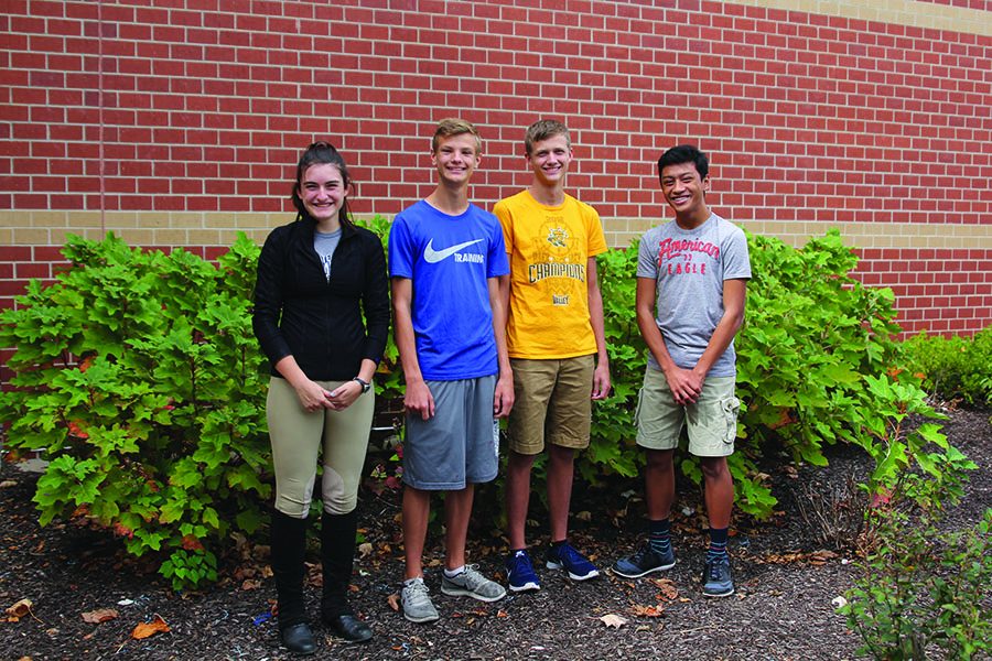 Using their burger expertise, junior Abby Hoepner, freshman Leif Campbell, senior Devin Mendenhall and sophomore Nico Gatapia taste four different burger patties from popular fast food chains in the Shawnee area on Sunday, Oct. 1.