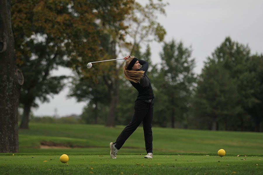 Using her driver, freshman Caroline Lawson hits the ball off the tee at the 5A regionals golf tournament on Tuesday, Oct. 10.