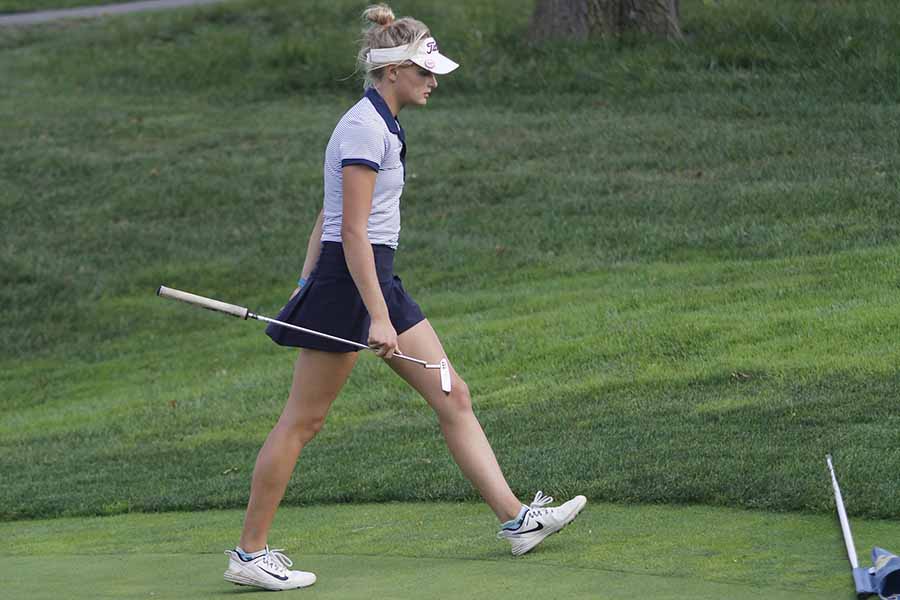 Senior Bella Hadden walks off after her putt at Lawerence Country Club golf course on Tuesday, Oct. 3.