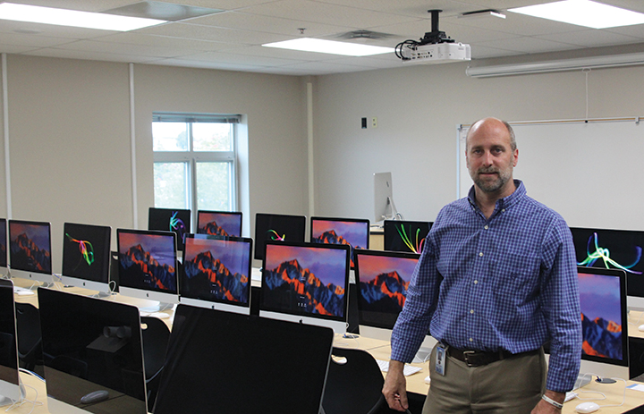 Standing in his new room, art teacher Jerry Howard “thinks that it will be exciting for him to have his own room just for Graphic Design.”   