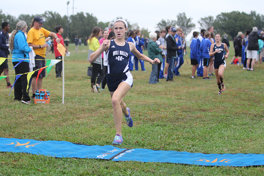 Crossing the finish line, sophomore Morgan Koca wins the girls varsity race at the Mark Chipman Cat Classic at Shawnee Mission Park on Wednesday, Oct. 4 