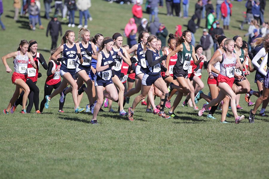 At the start of the race, the girls cross country team runs together.