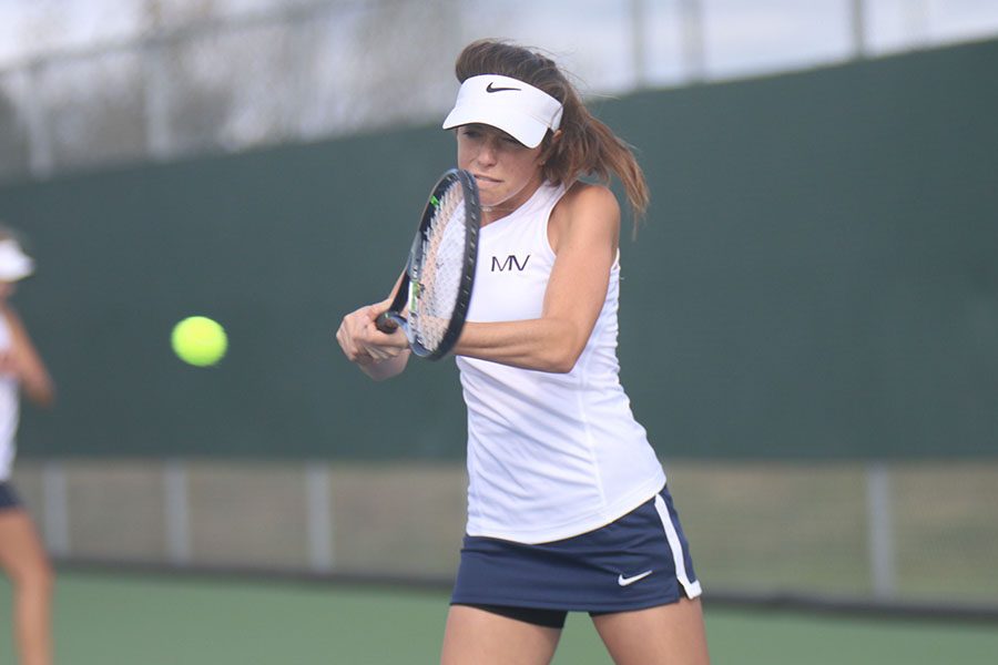 Freshman Sophie Lecuru attacks the ball with a powerful swing at regionals on Saturday, Oct. 7.