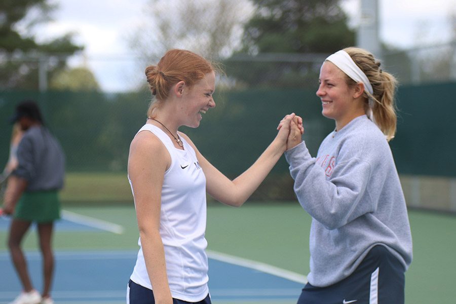 Junior Josie Carey and senior Peyton Moeder get excited after scoring a point that gets them ahead in their match.