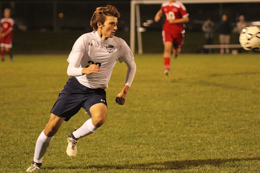 Sophomore Riley Ferguson looks at the incoming ball ready to kick it.