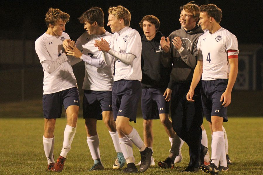 Soccer players on the bench join their teammates on the field after their win over Shawnee Heights on Thursday, Oct. 26. The Jaguars stomped the Thunderbirds winning 8-1, making them the regional champions. The Jaguars will play in the state quarterfinals on Tuesday, Oct. 31. 