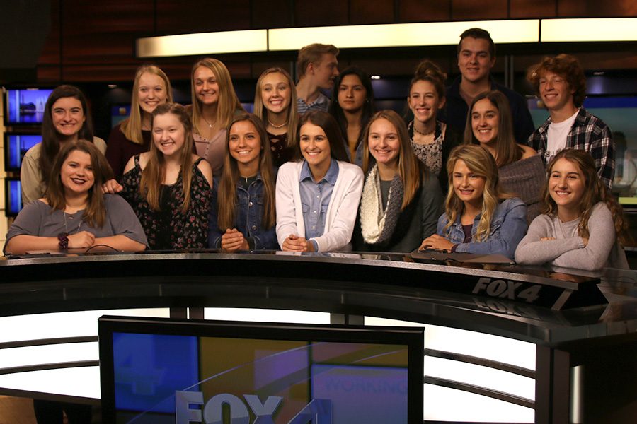 Half of the broadcast group poses for a photo in the Fox 4 News studio.