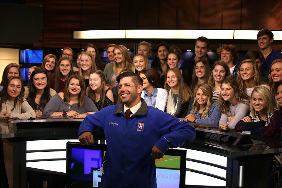 Fox News morning reporter Matt Stewart poses with the group of 34 Broadcast students in Fox 4s Studio A.