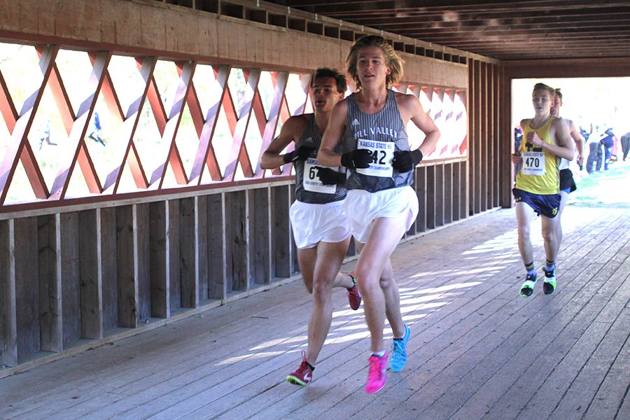 Crossing the bridge marking mile two of their race, seniors Mitch Dervin and Justin Grega continue running.