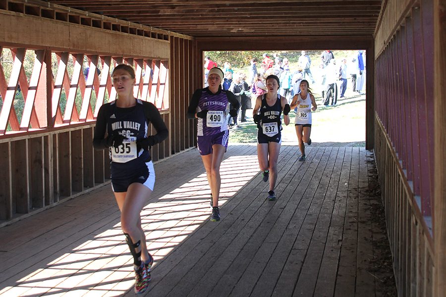 Leading the pack, senior Britton Nelson passes the two-mile mark of the course at Rim Rock Farm.