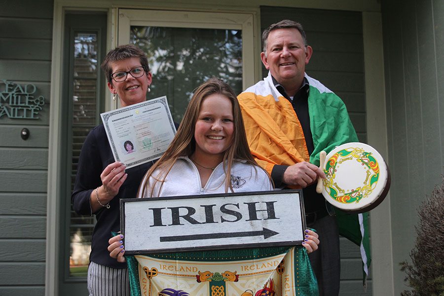 Joined by parents, junior Ciara Pemberton holds up a sign and a handkerchief representing her Irish heritage. 
