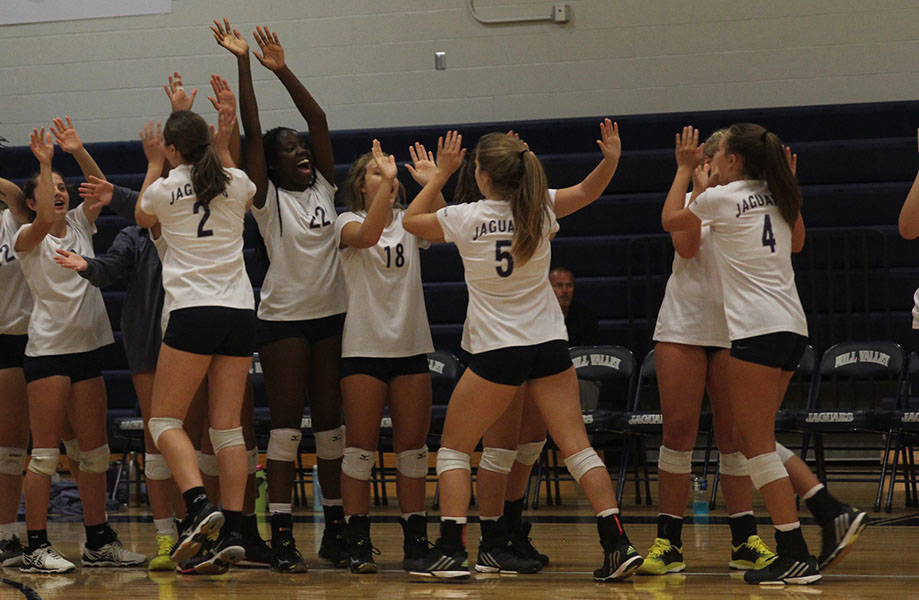 Before the game begins, players cheer and high five.