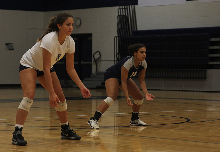 Senior Allie Harvey prepares to receive the serve from the opposing team.