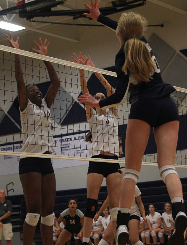 Junior Molly Cosmillo and senior Abby Archibong attempt to block a hit.