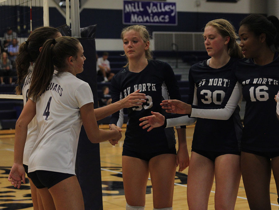 Freshman Molly Carr shakes hands with the opposing team, the Blue Valley North Mustangs. 