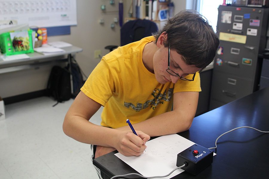 At a Quiz Bowl practice on Monday, Oct. 23, junior Will Hect solves a math problem.