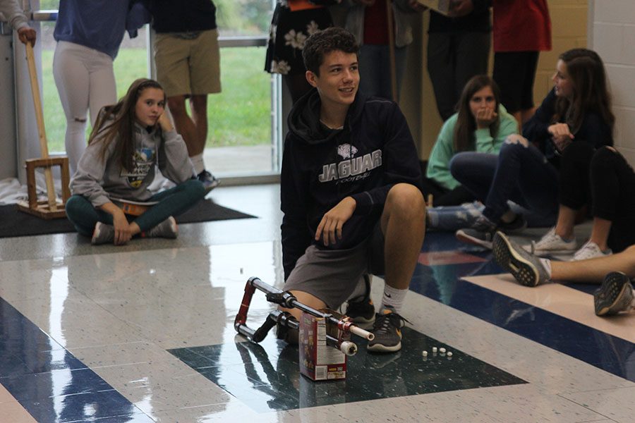 Preparing for his turn to launch his marshmallow on Tuesday, Oct. 10, junior TJ Smith listens to science teacher Chad Browns instructions.